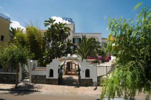 a white house with trees in front of it at Hotel Villa Angelica in Ischia