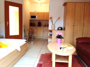 a living room with a couch and a table at Apartment Am Lübbesee in Templin