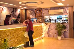 a woman talking on a cell phone at a bar at BH Hotels Tripper Near IGI Airport in New Delhi