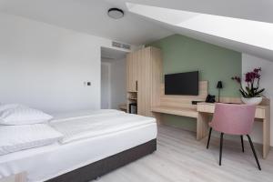 Postel nebo postele na pokoji v ubytování Hunguest Hotel Flóra