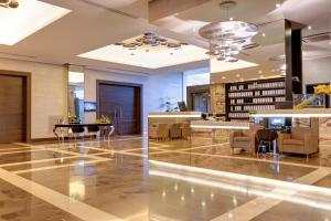 a lobby with chairs and a table in a building at Klima Hotel Milano Fiere in Milan