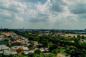 a cityscape of a town under a cloudy sky at Cozy and Comfort Studio Room at Poris 88 Apartment By Travelio in Tangerang