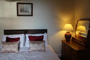 
a hotel room with a bed and a lamp at Brackness House Luxury B&B in Anstruther
