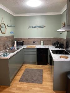 a kitchen with white counter tops and a stove at Beach House in Lytham St Annes +11 photos