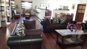 a living room with leather couches and a coffee table at Villa ASIA in Nosy Be +17 photos