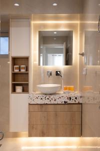 a bathroom with a sink and a mirror at Seaside Elegance Brand New 2BD Luxury Stay in Athens +14 photos