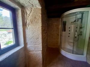 a bathroom with a shower with a window at Val Fresco Suites & Relax - casa rural in Curantes +40 photos