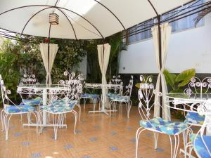 a group of tables and chairs under an umbrella at Hotel Savona in Arica