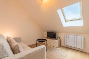 TV a/nebo společenská místnost v ubytování Appartement une chambre atypique + 10 fotografií