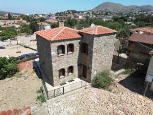 an old stone building with a city in the background at Dual İmroz in Gökçeada