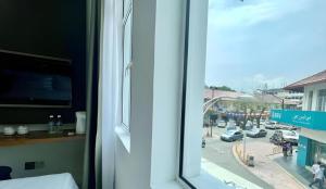 a view of a city street from a window at ATAP Hotel in Kota Kinabalu