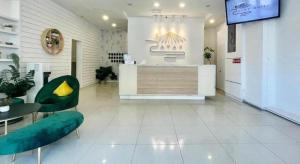 a lobby with a counter and a table and chairs at ATAP Hotel in Kota Kinabalu