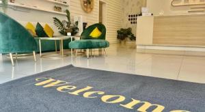 a room with chairs and a welcome rug on the floor at ATAP Hotel in Kota Kinabalu