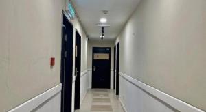 an empty hallway with a blue door and a hallwayngthngthngthngthngthngth at ATAP Hotel in Kota Kinabalu