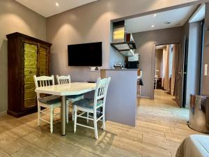 a kitchen and dining room with a table and chairs at Aux Gites Lorrains in Richemont