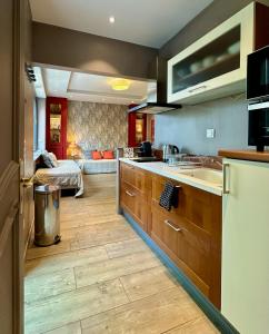a kitchen with a sink and a counter top at Aux Gites Lorrains in Richemont