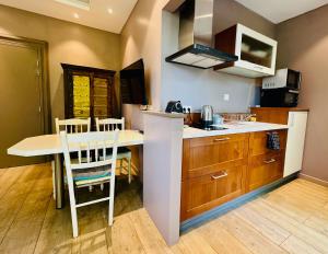 a kitchen with a table and some chairs in it at Aux Gites Lorrains in Richemont +11 photos