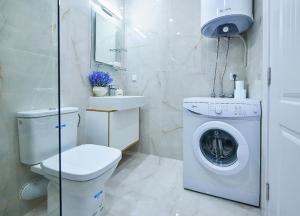 a bathroom with a toilet and a washing machine at Luxury Apartment Saint George Beauty and Style in Sveti Vlas +11 photos