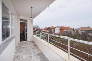 a balcony with a view of a city at Luxury Apartment Saint George Beauty and Style in Sveti Vlas