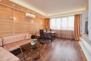 a living room with a couch and a table at Luxury Apartment Saint George Beauty and Style in Sveti Vlas