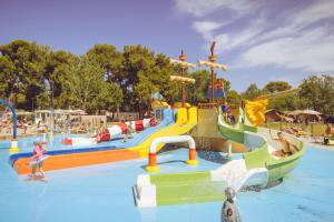 a water park with a water slide and people in it at Camping Bi-Village - Roan in Valbandon