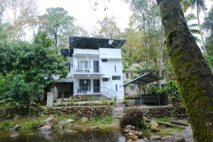 a house in the middle of a river at Riverside Bliss Villa in Kallar-Bridge