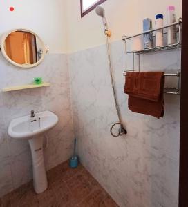 a bathroom with a sink and a mirror at Home in Ban Nong Hin