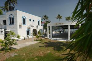 a white building with a sign that reads vlore at Voitto Vista in Cochin