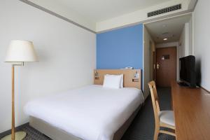 Postel nebo postele na pokoji v ubytování The Mark Grand Hotel