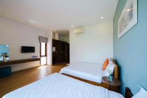 Postel nebo postele na pokoji v ubytování Green World Hoi An Villa + 42 fotografií