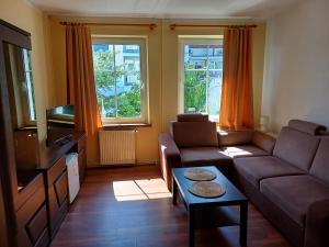 a living room with a couch and a tv at ORW Rzemieślnik in Międzywodzie