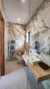 a bathroom with a sink and a toilet at Sunterra villa Seaview in Amphoe Koh Samui