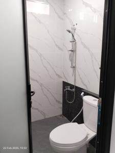 a bathroom with a toilet and a shower at Majid's Homestay Solo in Kartosuro