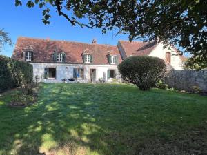 a large white house with a large yard at Détente au cœur du Perche in Senonches