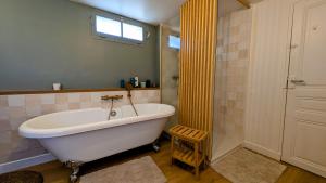 a bathroom with a large tub and a shower at Détente au cœur du Perche in Senonches +22 photos