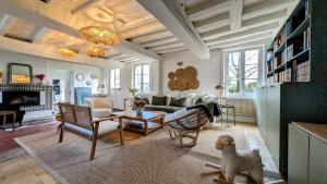 a living room with a couch and a table at Détente au cœur du Perche in Senonches