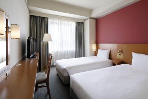 Postel nebo postele na pokoji v ubytování The Mark Grand Hotel