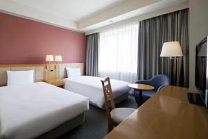 Postel nebo postele na pokoji v ubytování The Mark Grand Hotel