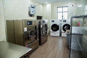 a laundry room with three washers and three machines at SkyLine View Hotel in Mama +11 photos