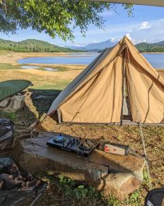 a tent sitting next to a body of water at Goin Out Camping Tam Kỳ in Phường Hòa (1)