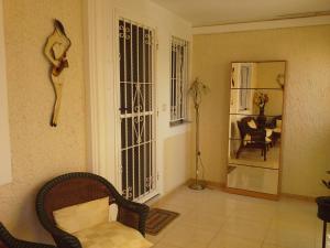 ein Wohnzimmer mit einem Stuhl und einem Spiegel in der Unterkunft Apartment 241 in Gran Alacant