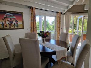 a dining room with a table and chairs at MaeStorm Gardens Relax:Reload:Refresh Private room in nature lodge in East London