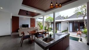 a kitchen and living room with a sink and a table at Chic 2BR Cozy & Private Pool at Bareng Villa in Ubud