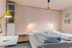 1 dormitorio con 2 camas y escritorio con ordenador en Veludstyret sommerhus i unik natur 350 m fra lækker badestrand - helårsbolig, en Saltum