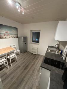 a kitchen and dining room with a table and a sink at Schöne Apartments in Frechen BM07 bis BM09 in Frechen