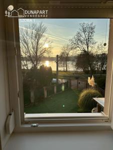a window with a view of a golf course at Dunapart Vendégház Esztergom in Esztergom +18 photos