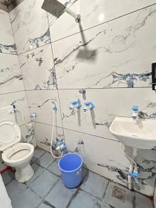 a bathroom with a toilet and a sink at Hotel Shree Siddhi vinayak in Ujjain