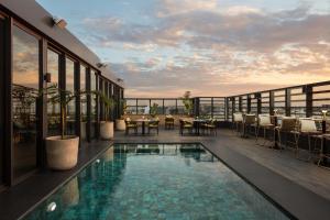 a rooftop patio with a pool on a building at Courtyard by Marriott Casablanca Downtown in Casablanca