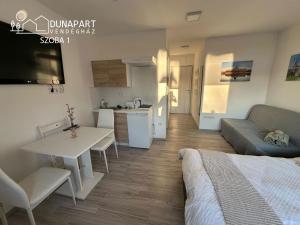 a small apartment with a kitchen and a living room at Dunapart Vendégház Esztergom in Esztergom