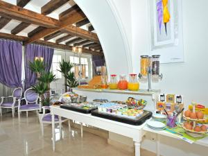 a buffet with food on a table in a room at Kyriad Saumur Hyper Centre Hôtel, Appartements, Séminaires et SPA soins Sothys Paris in Saumur